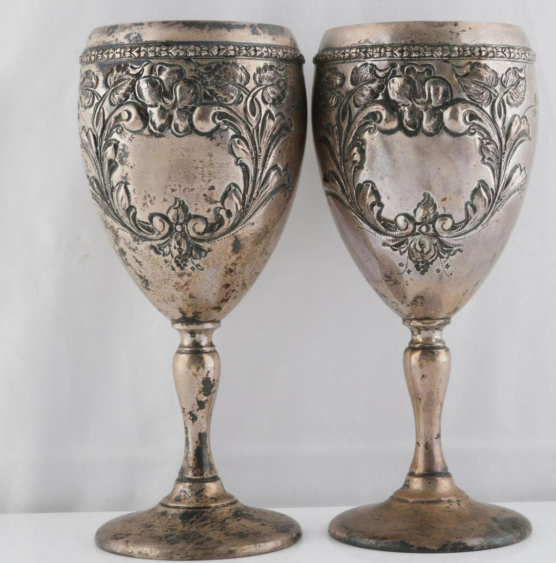 2 FISHER VIOLET STERLING SILVER WATER GOBLET: 2 Fisher sterling silver 7 inch water goblets, Violet pattern, each with hand chased floral decorations. Marked Sterling and Hand Chased to underside of bases. Not monogrammed, tarnished. Total weight