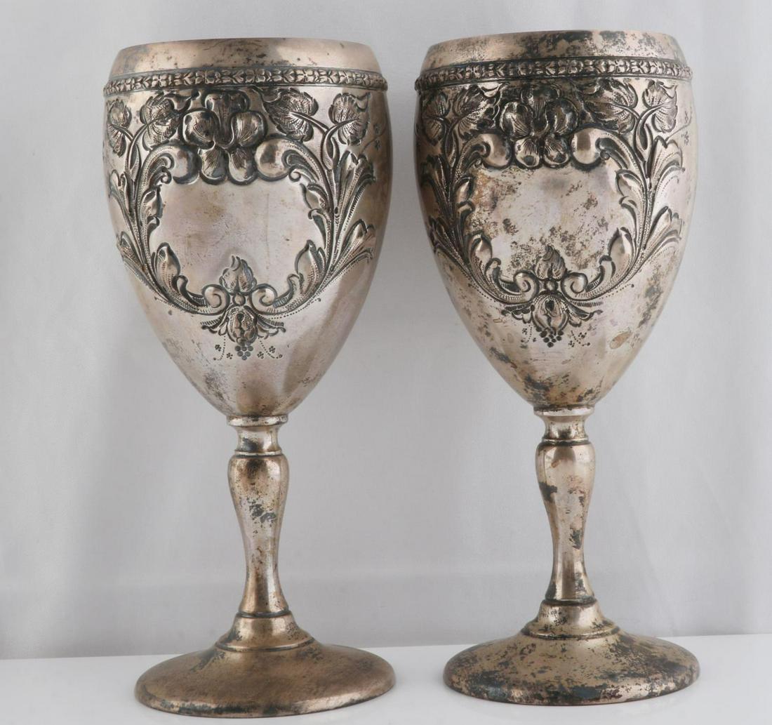 2 FISHER VIOLET STERLING SILVER WATER GOBLET: 2 Fisher sterling silver 7 inch water goblets, Violet pattern, each with hand chased floral decorations. Marked Sterling and Hand Chased to underside of bases. Not monogrammed, tarnished. Total weight
