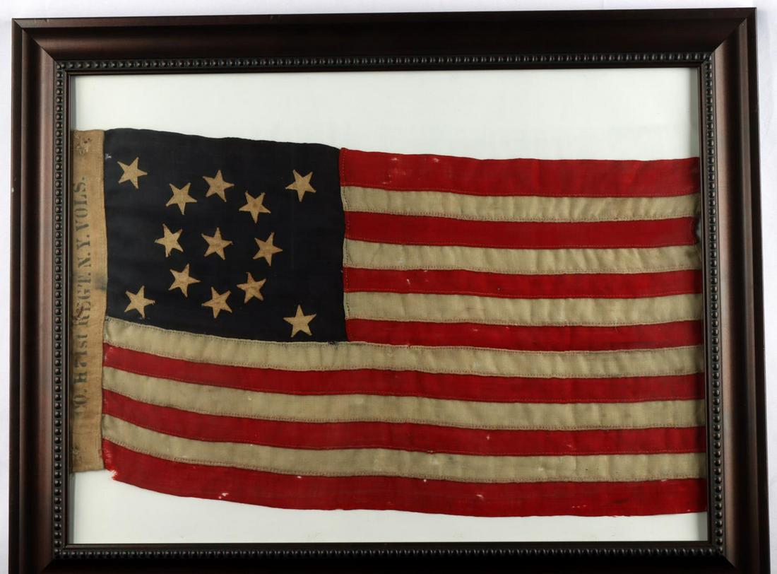 13 STAR 71ST INFANTRY REGIMENT OF NEW YORK FLAG: Wool construction. 13 stars. Hoist printed Co. H 71st Regt. N. Y. Vols. Measures 13 X 26 inches. Frame measures 22 X 28 inches. Very good condition. This lot has a reserve.
