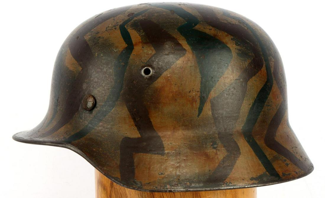 WWII GERMAN THIRD REICH ARMY M40 CAMO HELMET: Painted camo helmet with 8 finger leather liner. Size marked on liner but faded. Interior shell stamp on left side "064". Has stamp on metal band but difficult to see. Very good condition