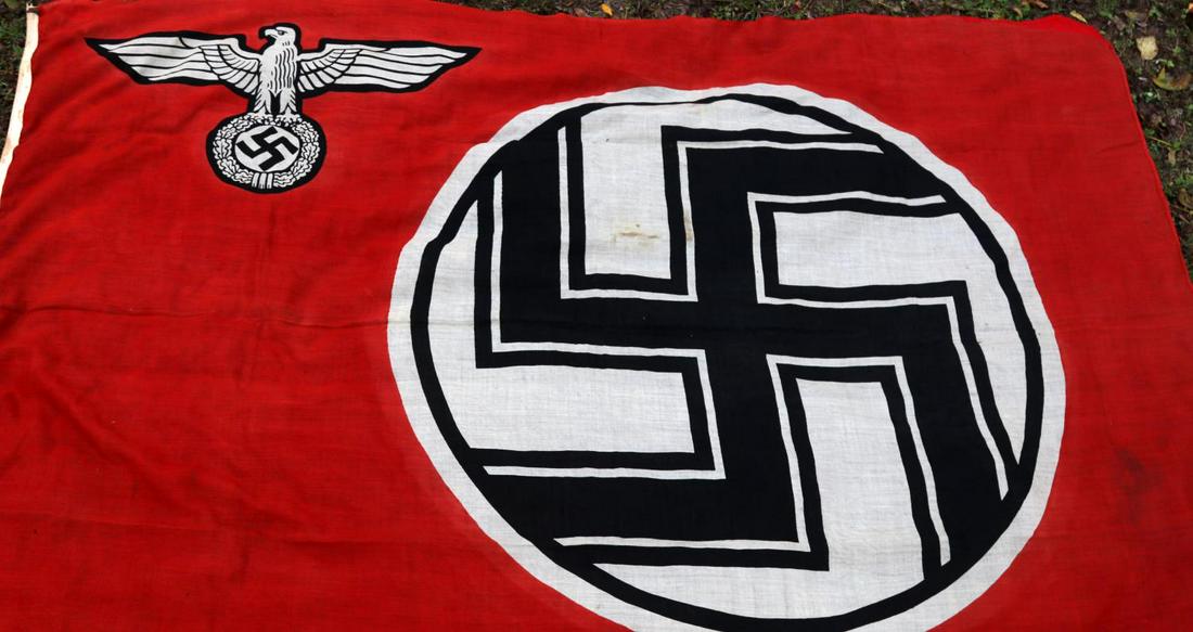 WWII GERMAN THIRD REICH STATE SERVICE FLAG: WW2 German double sided wool construction printed flag. The flag features a red base field with a white centered circular field and a black and white bordered black static swastika at the center and a