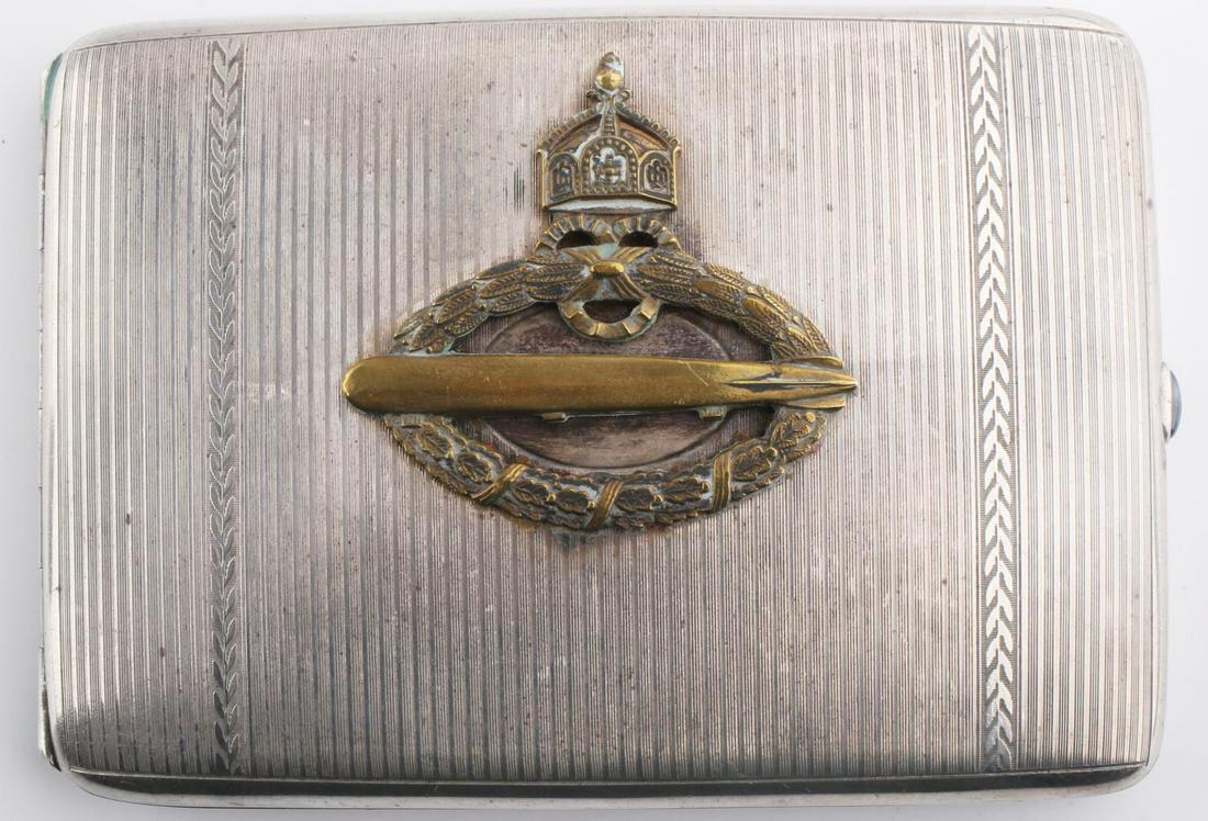 WWI GERMAN U-BOAT BADGE 935 SILVER CIGARETTE CASE: Hallmarked 935 and readily test with acid and electronically for purity of silver, Brass U-Boat badge affixed, Blue glass push button, 4 1/2 by 3 inches, very good original condition.