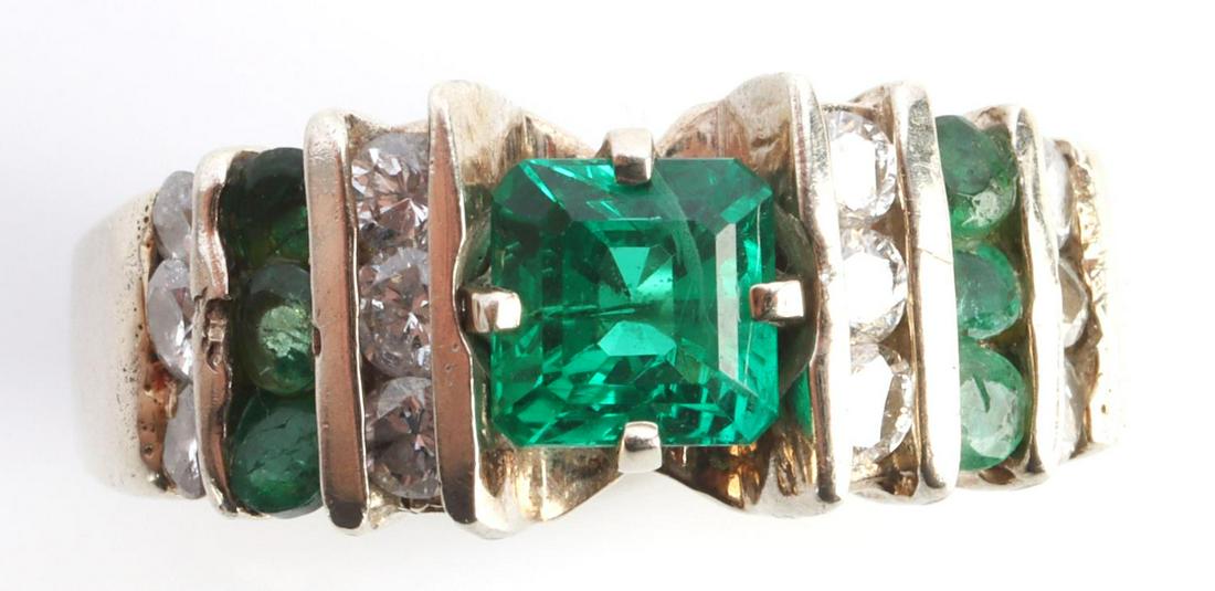 14KT WHITE GOLD DIAMOND AND TSAVORITE GARNET RING: 14kt white gold ring, unmarked but acid tested. Center stone is approximately a 1/2 carat emerald cut Tsavorite, green garnet. Accented by nine 1.5mm diamonds and six .5mm tsavorite gemstones. Size 5