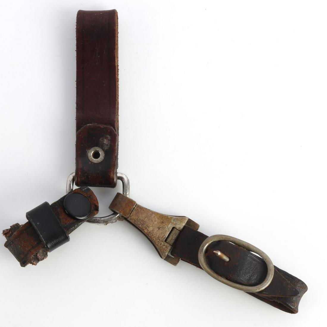 WWII GERMAN SA DAGGER THREE WAY HANGERS: WWII German SA dagger 3-way hangers. Dark brown leather hangers with all leather intact. Maker marked clasp illegible. Overall good condition with signs of aging and wear. 7 inches long. This lot has