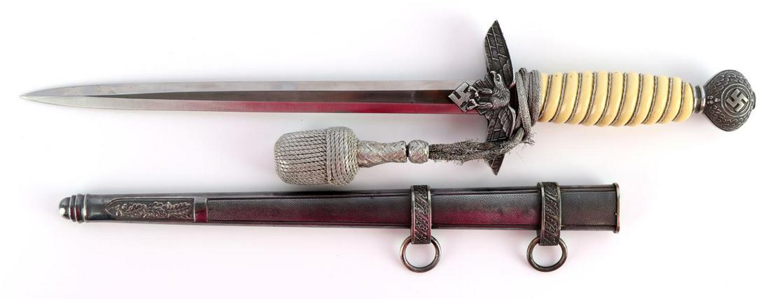 WWII GERMAN LUFTWAFFE 2ND MODEL DAGGER W SCABBARD: WWII German 2nd model Luftwaffe dagger with scabbard and portepee. Off white celluloid with wooden core grip with silver colored twisted wire wrapped. Aluminum crossguard, ferrule, and pommel. Bright