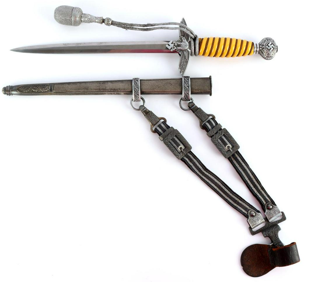 WWII GERMAN LUFTWAFFE HORSTER DAGGGER W SCABBARD: WWII German Luftwaffe 2nd Model dagger with scabbard, hangers, and portepee. Orange bakelite grip with twisted brass wire wrapped with loss near the ferrule. Aluminum pommel, crossguard, and ferrule w