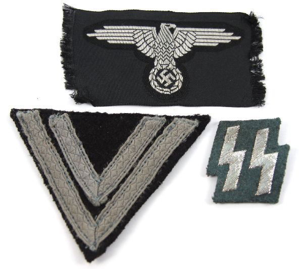 SS SLEEVE CHEVRON COLLAR TAB AND BREAST EAGLE: Lot of SS insignia items. Sleeve chevron, green runic collar tab, and breast eagle. Breast eagle has some fraying at sides, otherwise all are in very good condition.