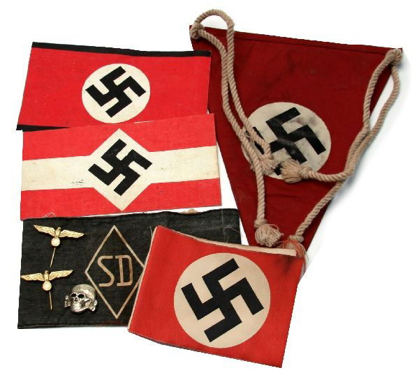 GERMAN WWII THIRD REICH ARMBANDS PENNANTS & MORE: Collection of WWII German Third Reich gear. Lot includes four arm bands, one pennant, two stick pins, and one visor pin. Two of the arm bands are constructed out of paper, one features Adolf Hitler st