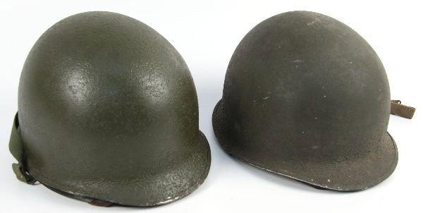 WWII M1 FIXED BALE & SWIVEL W 2ND ARMOR DIV HELMET: Pair of WWII M-1 helmets. The first is a fixed bale and shell early parkerized issue. The second is a center seam parkerized with a 2nd armor insignia shell.