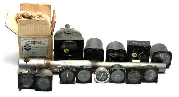 WWII FIGHT AIRCRAFT INSTRUMENTS & P-40 BLAST TUBE: Collection of what is most likely P series instruments and gauges, Altimeter, Compass, Directional indicator, Manifold Gauge and more. Altogether 13 gauges and a P-40 .50 caliber Blast Tube.