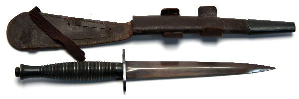 WWII THIRD PATTERN FAIRBAIRN-SYKES KNIFE SHEFFIELD: WWII era Third pattern Fairbairn - Sykes commando fighting knife. Ring grip, with no ricasso mark. Marked arrow over "21" and "England" on cross guard. Blued blade, in very good condition. Leather sca