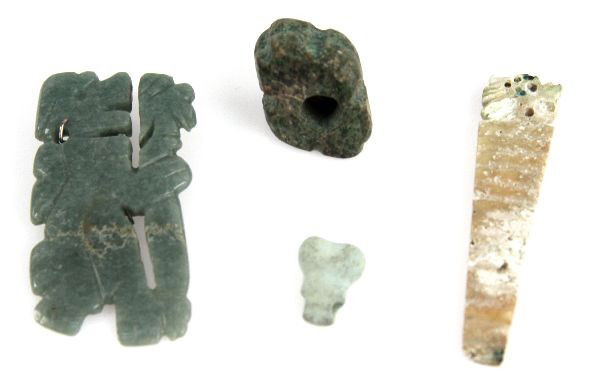 LOT OF PRECOLUMBIAN JADE AND SHELL EFFIGIES: Lot of Pre-Columbian jade and shell effigy pendants including jade 3 by 1.5 inch staff bearer, jade 1 by 1 inch bead, shell 3 by .75 inch avian pendant, and a .5 by .5 inch phallic pendant. Pieces are