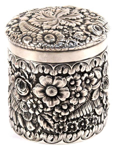 TIFFANY & CO 1883 STERLING SILVER DRESSER BOX: Unhinged lid box measures approx. 2.5 inches by 3 inches. It is deeply hand tooled repousse with floral and fern patterns, interior is gold washed, marked on the underside with "Tiffany & Co/7662M8178