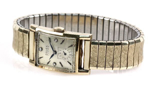 MEN'S VINTAGE 14K GRUEN CURVEX PRECISION WATCH: Men's vintage 14K Gruen Curvex Precision watch, with faceted crystal. Diamond set dial features blue hands. Band has been replaced, and is 10K gold plated. Serial number is 363665. Size: 21mm Weight: