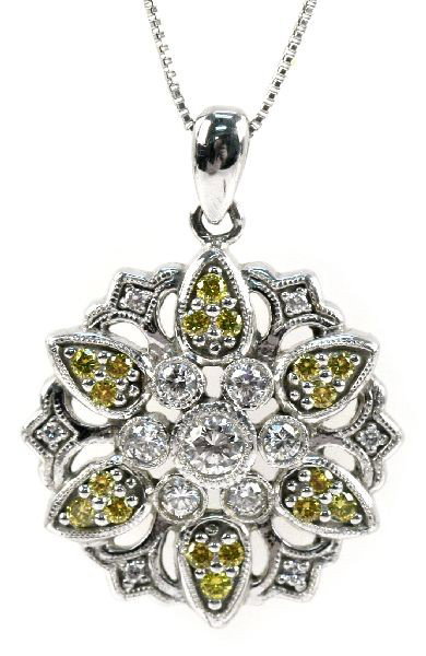 14K CANARY AND WHITE DIAMOND PENDANT 0.5 CTW: Ladies 14K white gold pendant featuring white and canary diamonds in floral medallion pattern, 0.5 CTW; pendant is on 18 inch 14K white gold box link chain. Size: 18 in. Weight: 4.9 g Condition: Very 