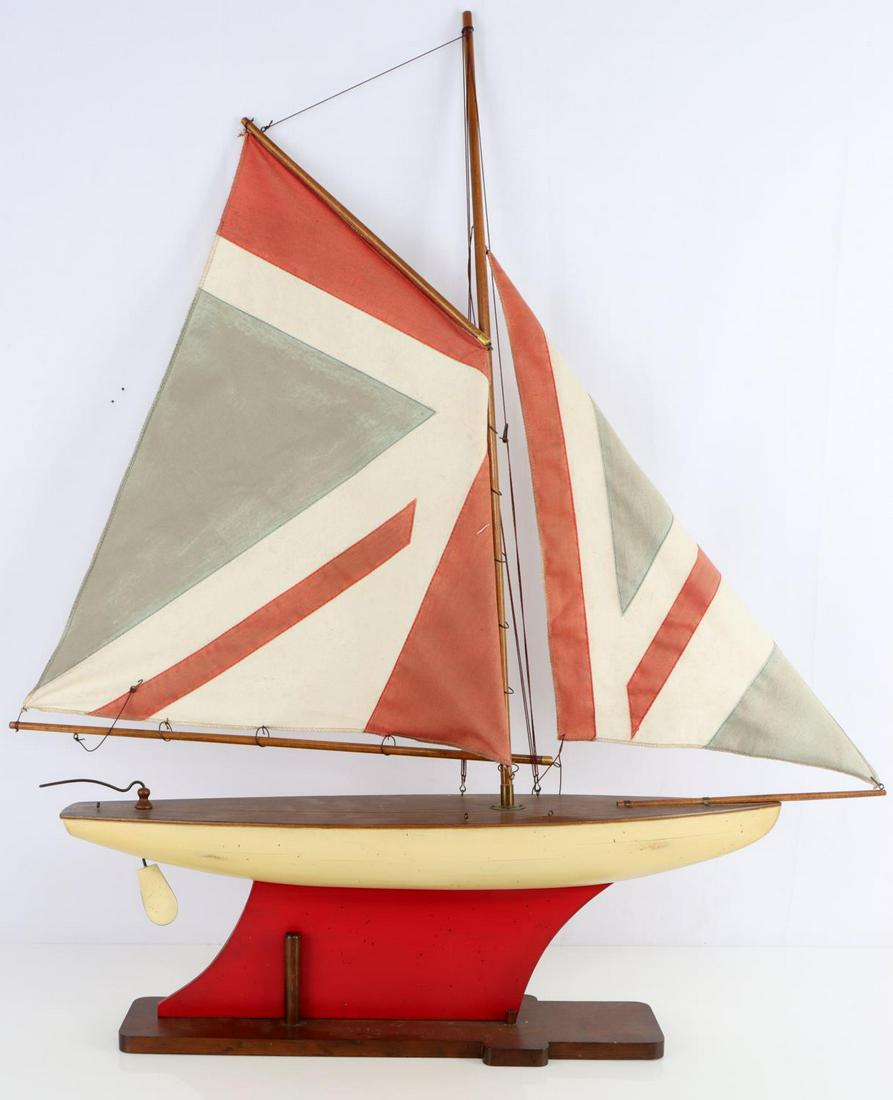 VINTAGE POND YACHT WOOD MODEL SAILBOAT: Condition: Overall good with cradle, sails have sun fading, linear cracks to hull paint with no chipping or loss.