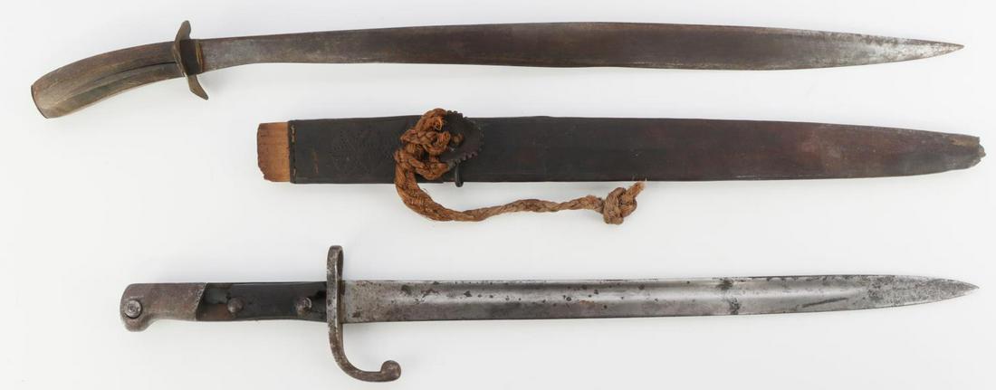 ANTIQUE FILIPPINO BOLO AND GERMAN BAYONET: Bolo measures 24 inches and comes with wooden scabbard. Bayonet measures 20 inches and is marked A315. Good condition.