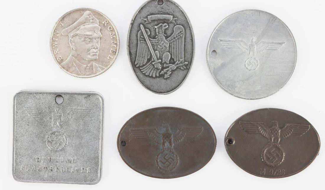 LOT 5 WWII GERMAN ID TAGS GESTAPO ETC + 1 ROMMEL: Total lot of six (6) includes Gestapo, Prussian secret police, Army secret field police, Rommel Afrikakorps round, and more. Four (4) are numbered. Some wear. Items are unauthenticated, sold "as is". 