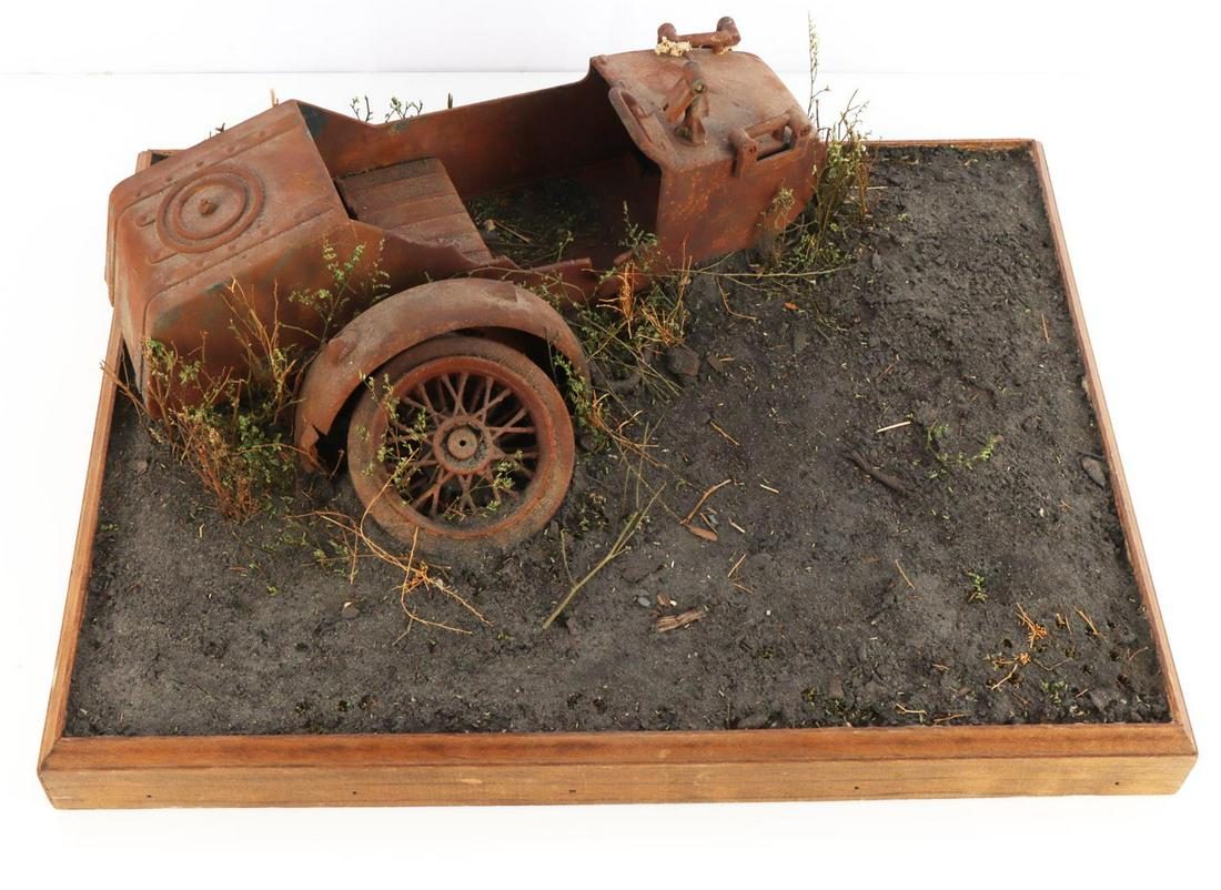 WWII GERMAN DIORAMA W DESTROYED MOTORCYCLE SIDECAR: WWII German diorama with destroyed motorcycle sidecar. On wooden base diorama measuring 16 1/2 inches wide by 12 11/16 inches deep. Car measures about 4 1/4 inches tall from base. Plants strewn about 