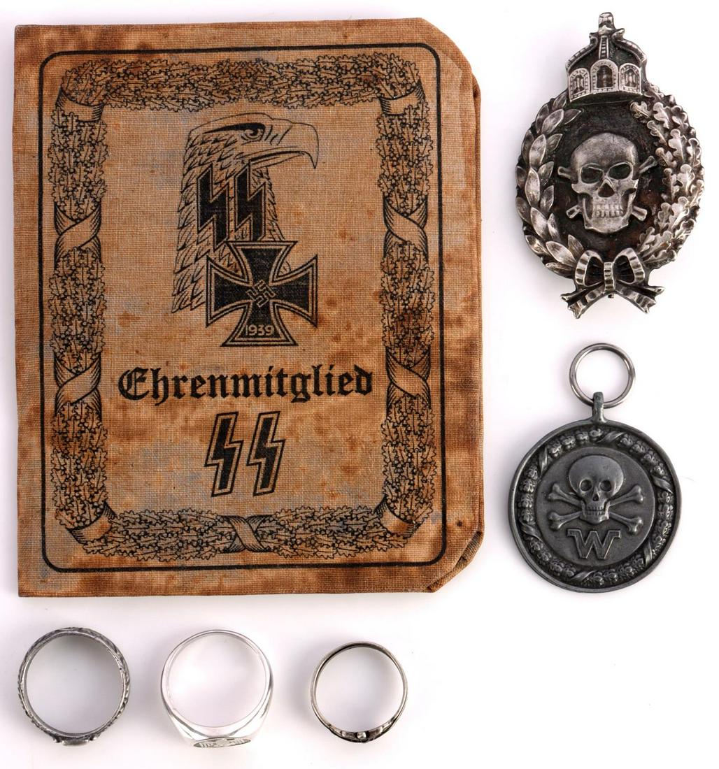 WWII GERMAN THIRD REICH LOT OF 7 HIMMLER RING SS: Lot features a Himmler honor ring, a Kriegsmarine ring, an NSDAP party ring, and an SS panzer id booklet. Ring sizes 10 - 13.5. Unauthenticated, sold as is.