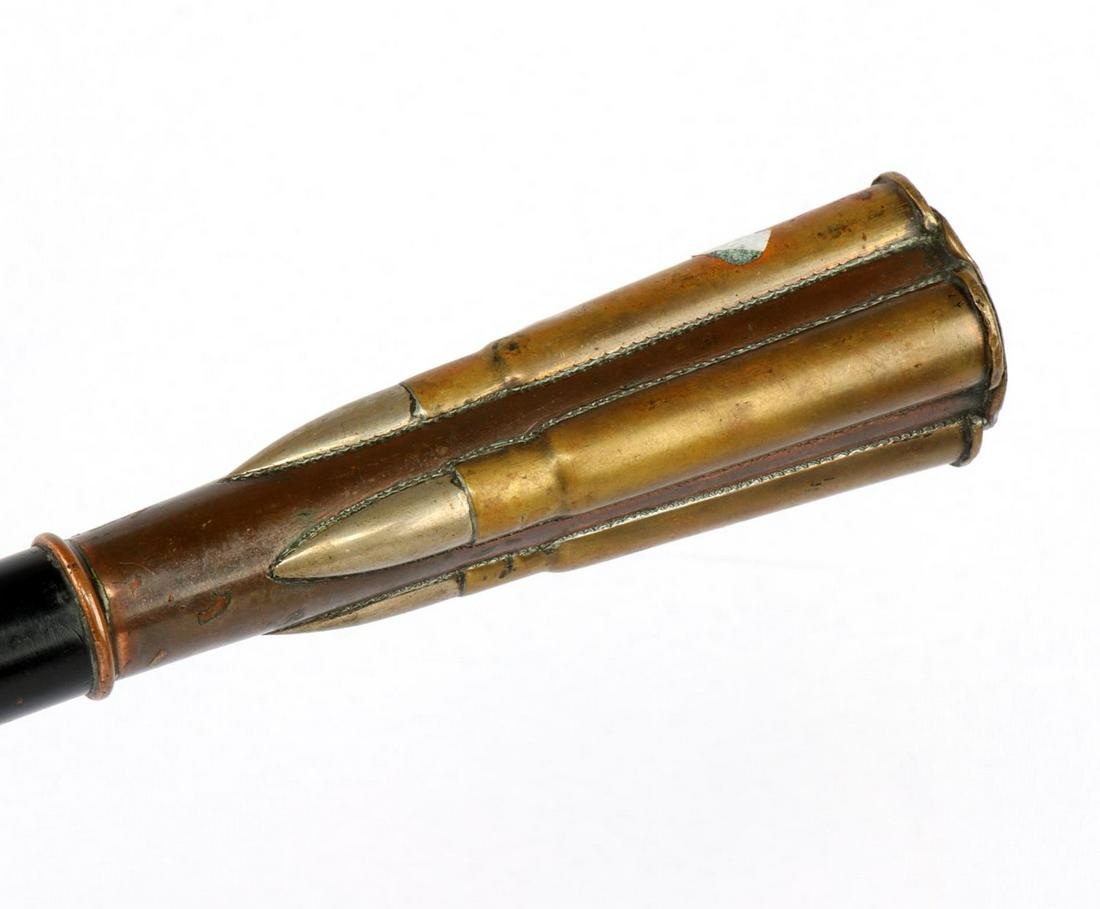 WWI TRENCH ART BULLET TOP WALKING CANE STICK: With Kings Crown general service button and 4 Enfield rounds. Features ebonized wood shaft with horn ferrule tip and has an overall length of 36 inches.