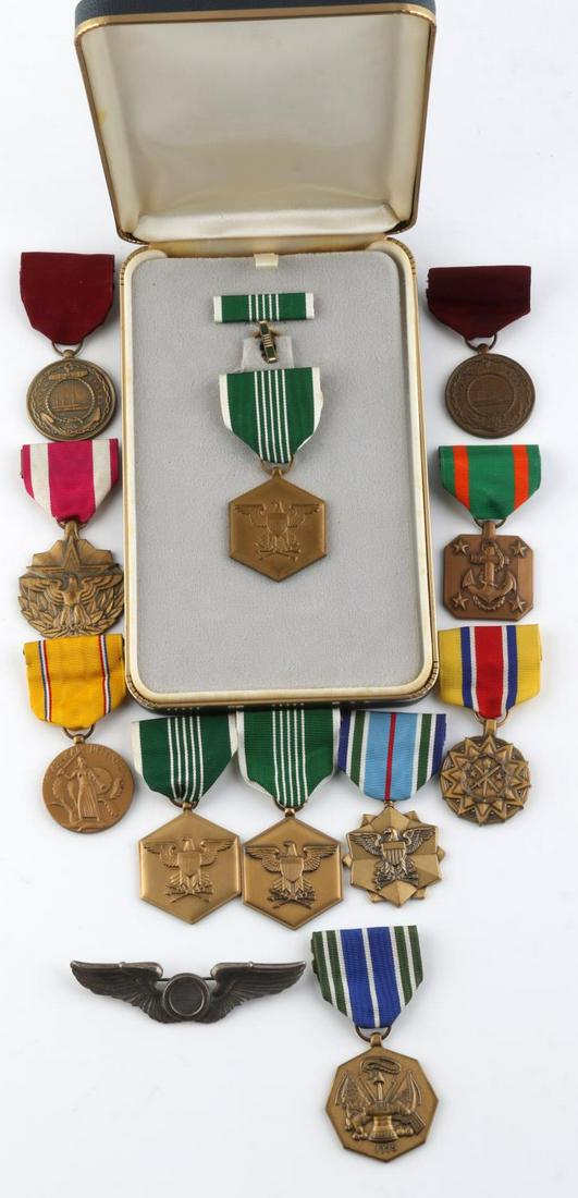 12 US MILITARY MERIT SERVICE MEDALS CASED & LOOSE: 11 medals, one army commendation medal is cased with bar and ribbon included. None are named. One set of breast eagles included. All in good condition. Unauthenticated, sold as is.