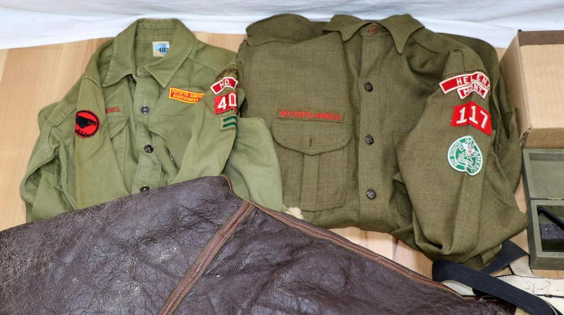 VINTAGE MILITARY BOYSCOUTS KNIFE LOT AND MORE: Lot features 2 Boy scout tunics, a military periscope, A2 sight line level, badges, flags, boot knives measuring on average 8 inches, an HS air pistol, and more. Very good condition.