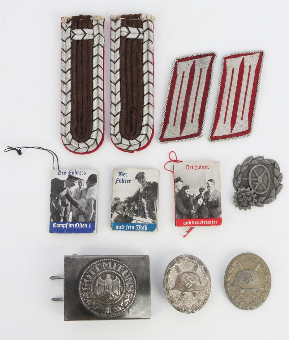 WWII GERMAN BELT BUCKLE WINTER HELP BOOK MEDAL LOT: Includes Heer belt buckle stamped DRF& CO 42, 3 Winter Help ornament books, 2 wound badge 1 without pin, RAD driver specialty badge, shoulder straps and collar insignia. All very good original conditi