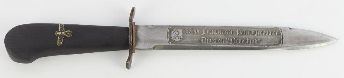 WWII GERMAN WAFFEN SS NEDERLAND BAYONET W SCABBARD: WWII German Waffen-SS 23rd Division presentation bayonet with scabbard. Black wooden handle with a golden Reichsadler. Blade division etched '23. SS-Freiwilligen Panzergrenadier Division "Nederland"'.