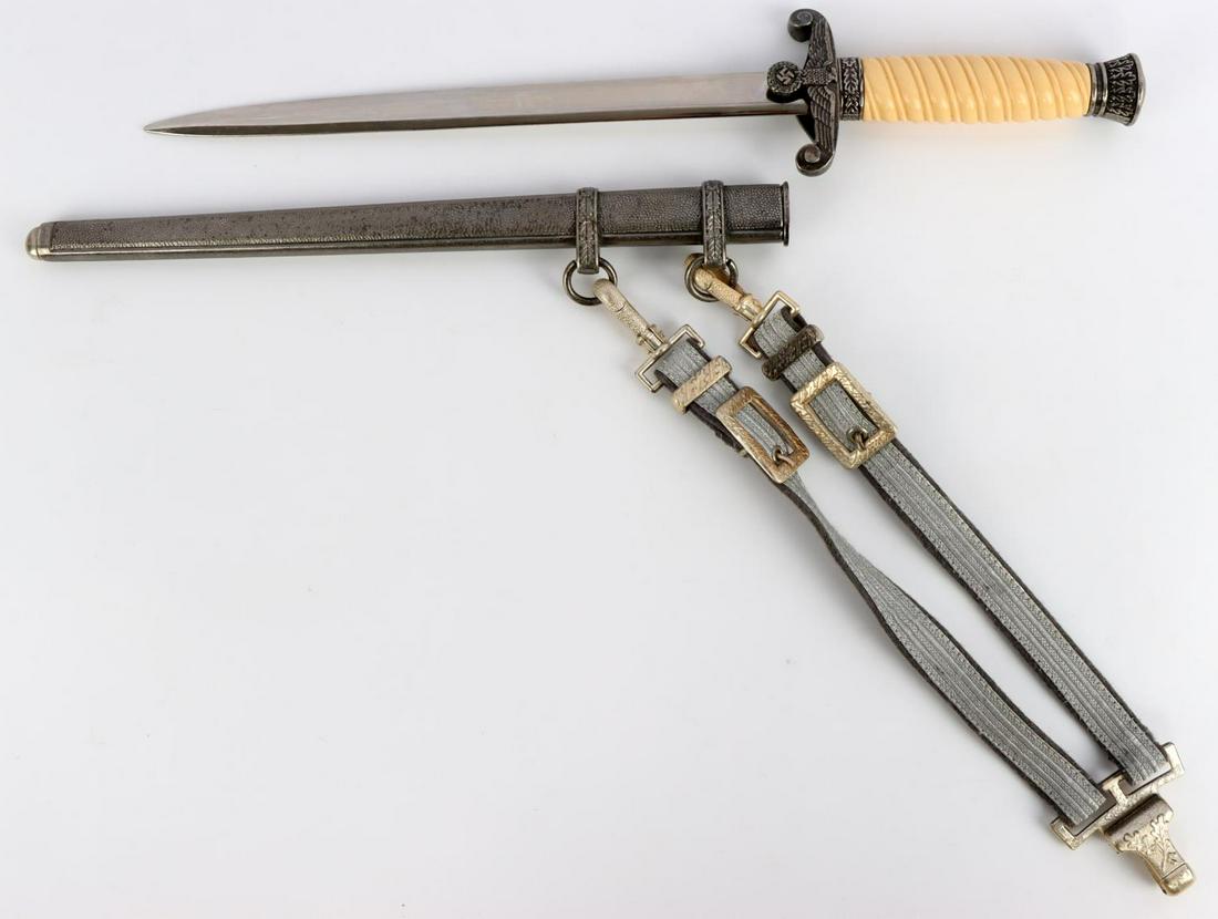 WWII GERMAN HEER ARMY DAGGER WITH SCABBARD: Reproduction WWII German Heer dagger with scabbard and hangers. Aluminum pommel, crossguard, and ferrule. Cream celluloid grip. Bright and clear blade maker marked Holler. Matching aluminum pebbled sc