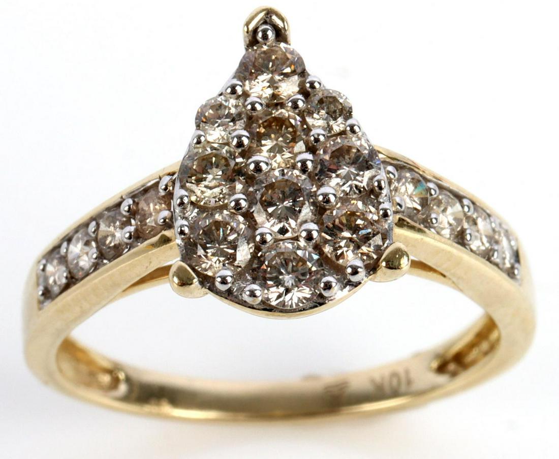 .67 CTW DIAMOND CLUSTER 10K YELLOW GOLD RING: Stamped "10K" inside shank. Diamonds are shared prong set in white gold, eye clean, round cut and L-N in color. Pear shape of ring measures 11.4 millimeters in length. Ring is a size 7 and in very goo