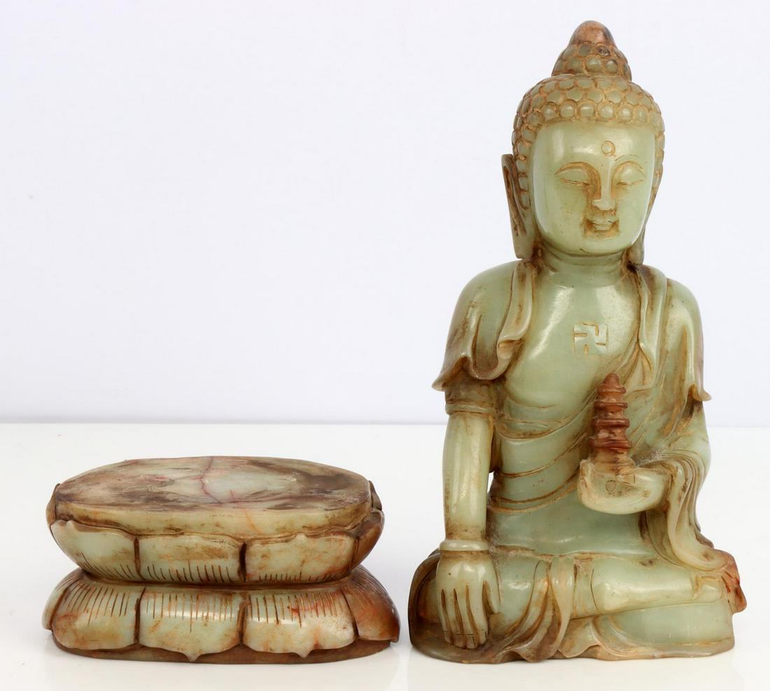 GREEN SOAPSTONE SEATED BUDDHA SINGLE LOTUS: Single lotus position. Swastika in the center of the chest. Comes with soapstone base. Very good condition. Measures 12 inches. This lot has a reserve.