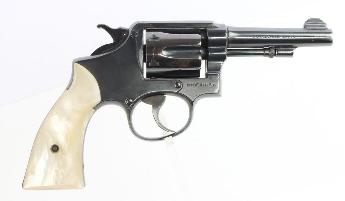 SMITH & WESSON M1917 DA .38 SPL REVOLVER: Barrel measures 4 inches long and features a bright and clear bore with good rifling. Action is smooth and functions without issue. Light surface loss in certain areas. Left mother of pearl grips with