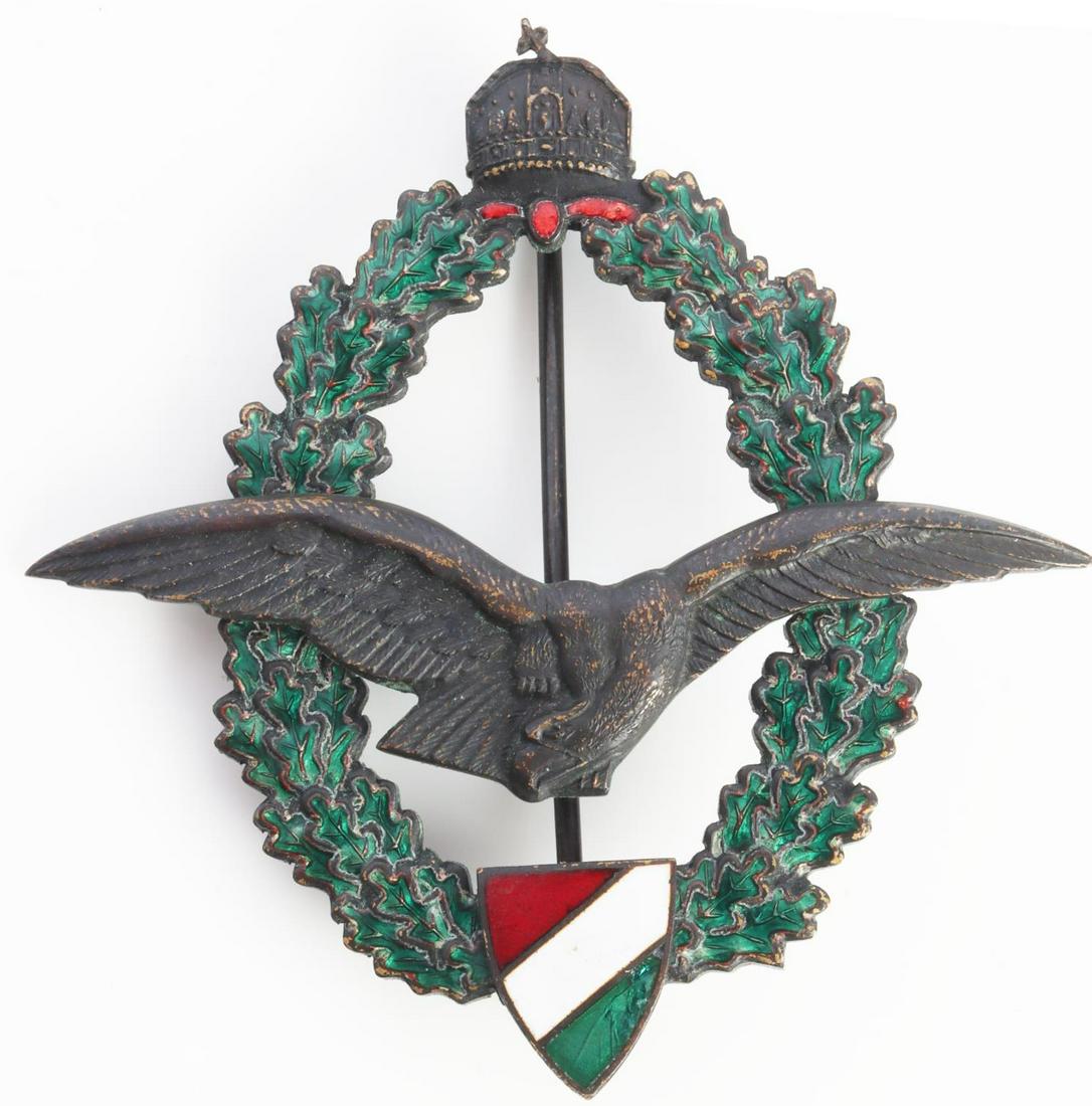 WWII HUNGARIAN AIR FORCE PILOTS BADGE: WWII Hungarian Air Force Pilot's badge. Obverse features flying eagle to center with St. Stephen's crown to top and the Hungarian national color shield to bottom with an oak leaf wreath. Enamel in ver