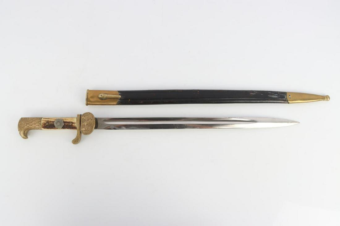 WEIMAR REPUBLIC POLICE SWORD CLAMSHELL DAGGER: Long pattern. Poor sharpening job carries throughout blade with visible scratching. Carl Eickhorn maker's mark on blade ricasso. Stag grips and pommel in good condition with very good detail. Scabbard