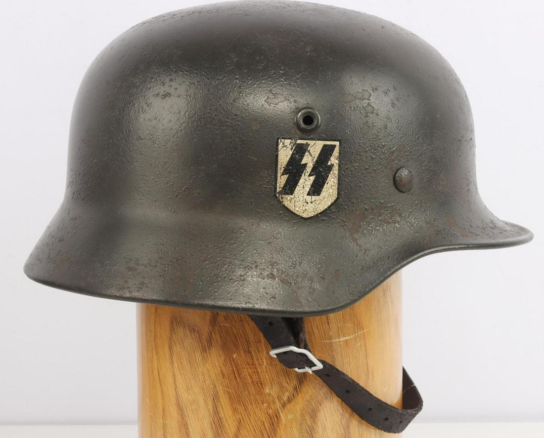 WWII GERMAN M-40 WAFFEN SS SINGLE DECAL HELMET: WWII German M-40 Waffen SS single decal helmet with molded rivet.. "Q68" stamped on side and "7940" stamped on crown of helmet. 9 Finger leather liner and chin strap intact and stamped 1939. Some wear