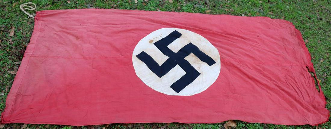 WWII GERMAN THIRD REICH LARGE NSDAP BANNER FLAG: Measures 120 X 56 inches. Overall very good condition with some staining and tearing at the edge. Non-fluorescing. Multi-piece construction.