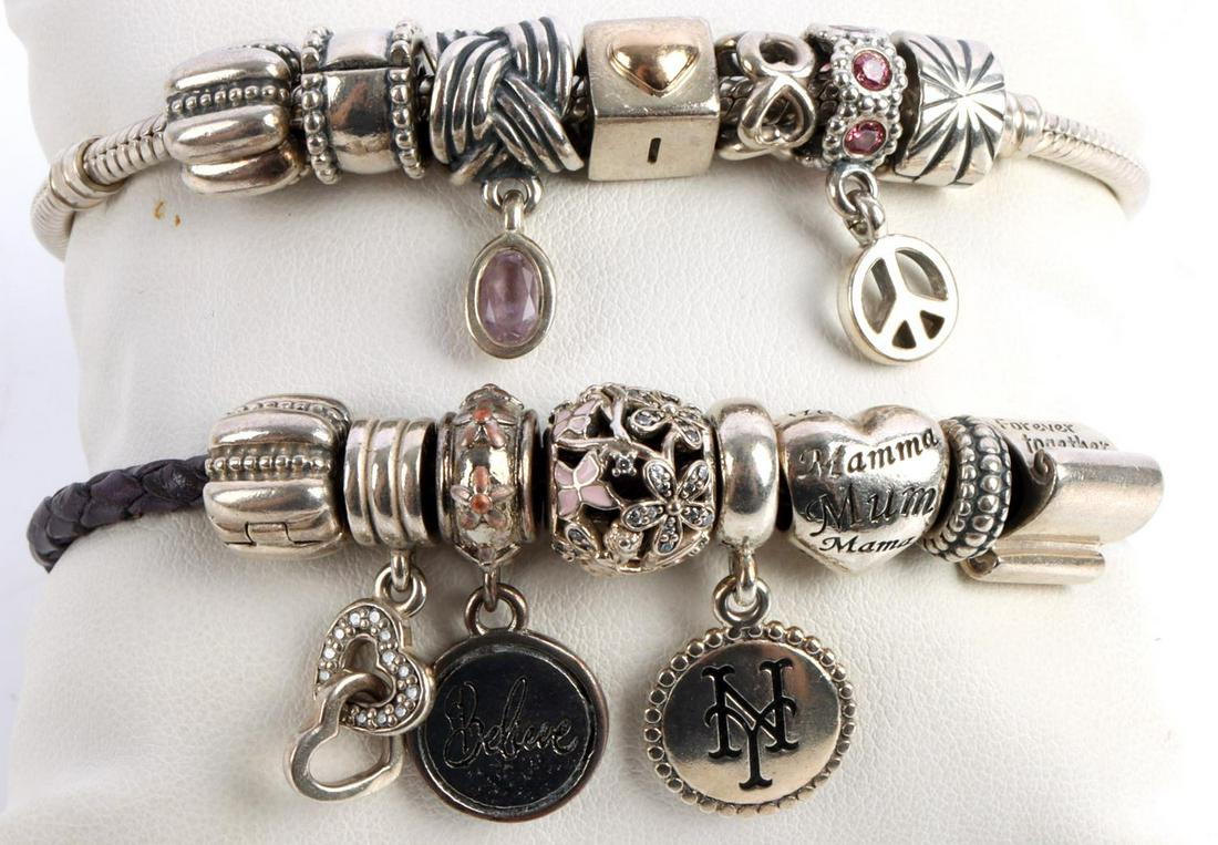 PANDORA STERLING SILVER BRACELET & CHARMS: 2 Pandora bracelets, one sterling and the other purple leather and sterling silver. There are a total of 15 charm attachments. This lot has a reserve.