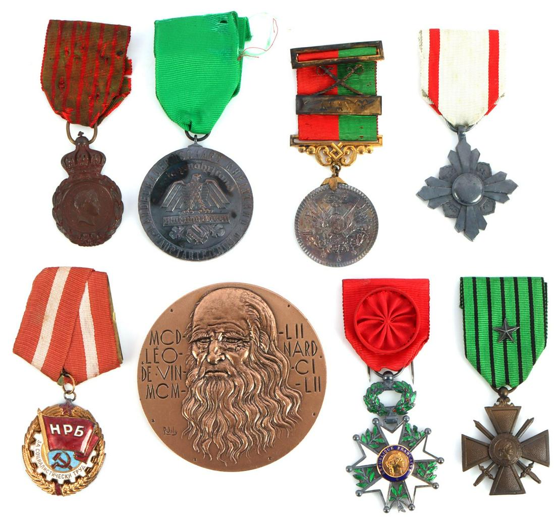 LOT OF 8 MILITARY MEDALS DA VINCI JAPANESE RUSSIAN: Lot features a variety of medals from Russia, Japan, the Middle East, Germany, and more. Very good condition. Measurements range 1 3/4 - 3 1/8 inches. This lot has a reserve.