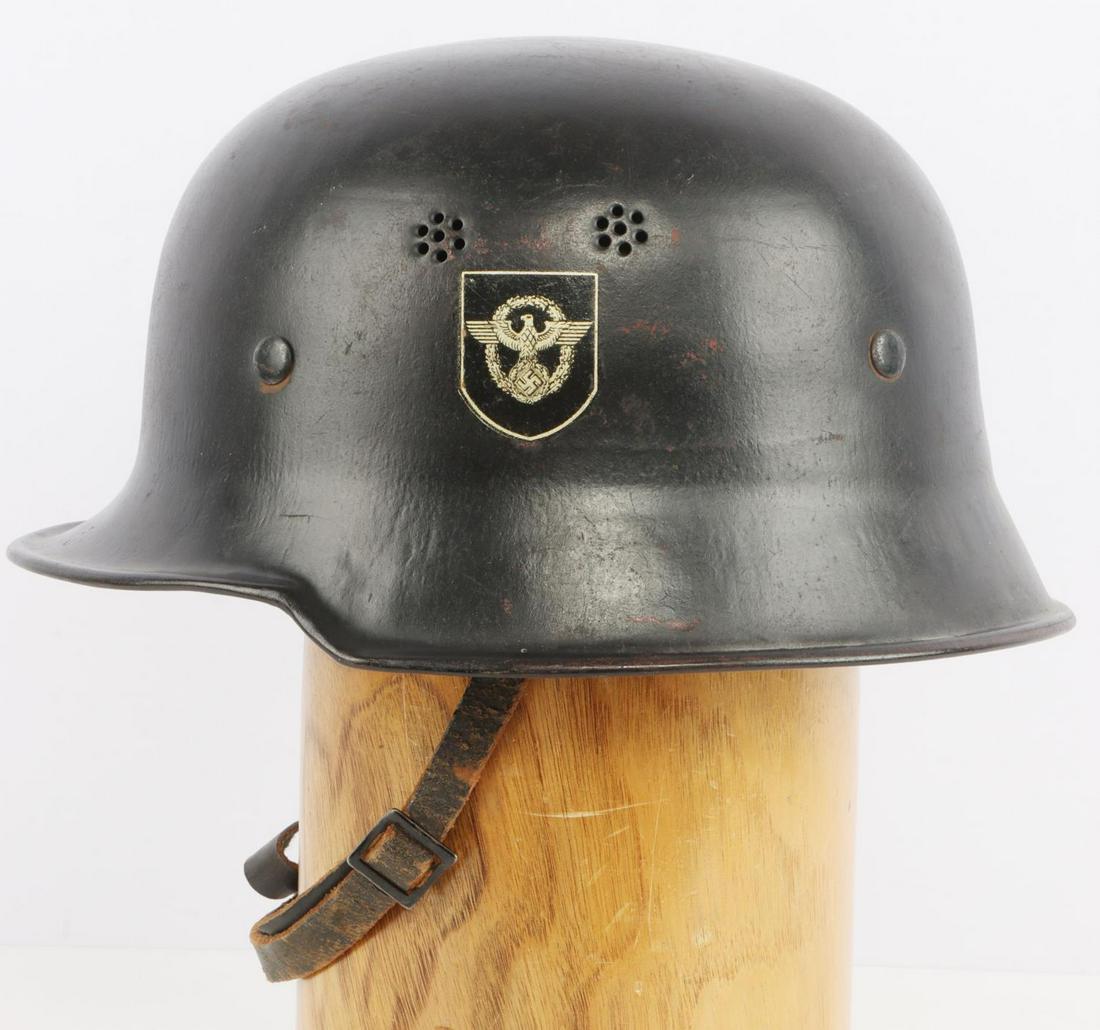 WWII GERMAN CIVIL POLICE DOUBLE DECAL HELMET: WWII German Civil Police double decal helmet with liner. Black painted steel shell with police (left) and NSDAP (right) shield decals. Heat stamped interior rear skirt with a T in a diamond. 9-finger 