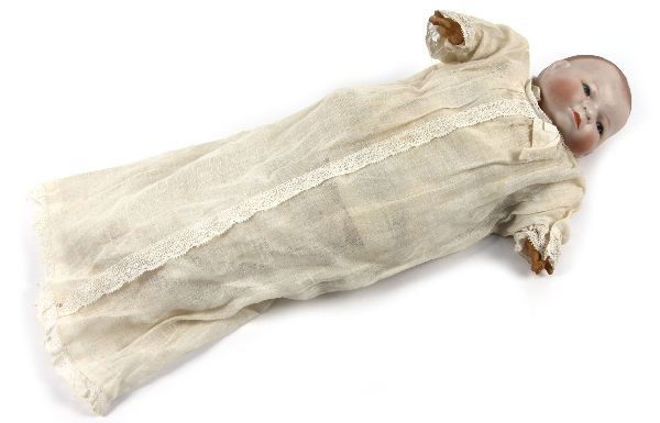 GRACE PUTNUM BYE-LO-BABY DOLL IN ORIGINAL CLOTHES: Bisque head is marked with incised Grace S Putnum marks. Cloth body has stamp on front. Composite hands. Cloth legs and feet. Very good condition with original diaper and sleeping dress. Doll is 11 in