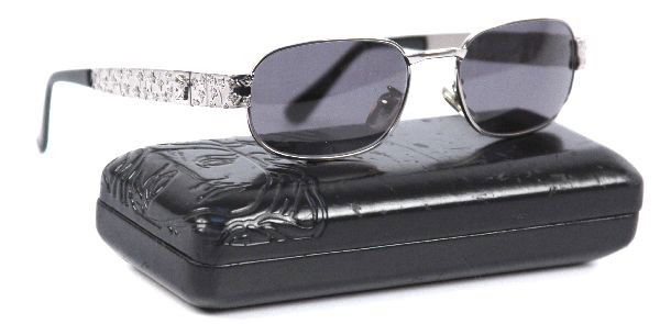 VERSACE METAL FRAME SUNGLASSES MOD X03 COL 029: VERSACE METAL FRAMED SUNGLASSES, with gray radiant lenses and black VERSACE carry case. The sunglasses are in very good condition with only a minor scratch on the inside of one ear frame. The case is