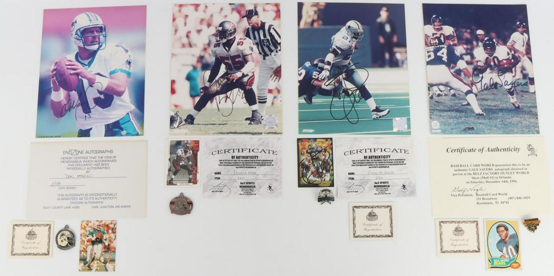 4 NFL AUTOGRAPHS EMMITT SMITH SAYERS MARINO BROOKS: Assortment of 4 NFL players autographed photographs. Includes Emmitt Smith, Dan Marino, Derrick Brooks, and Gale Sayers. All with COAs, pins, and cards. All signatures are clear. Very good condition.