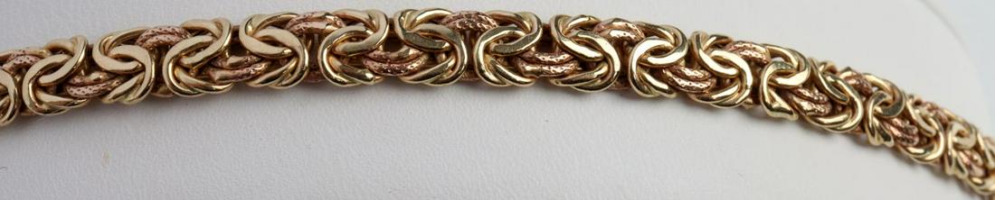 14K TWO TONE GOLD BYZANTINE LINK BRACELET: Stamped "14K" on clasp and bracelet. Total weight of 7.3 grams and measures 6 millimeters wide. In very good condition without damage or repairs. This lot has a reserve.