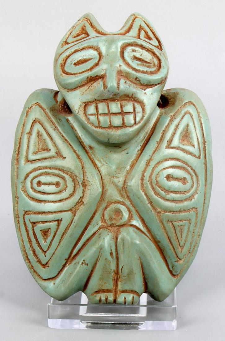 TAINO PRECOLUMBIAN BAT MAN PENDANT: Taino. PreColumbian. An fantastic bat man pendant with bat man on front. Head is relief carved, standing out from the pendant body. Eyes are closed and teeth barred possibly referencing an intense hal