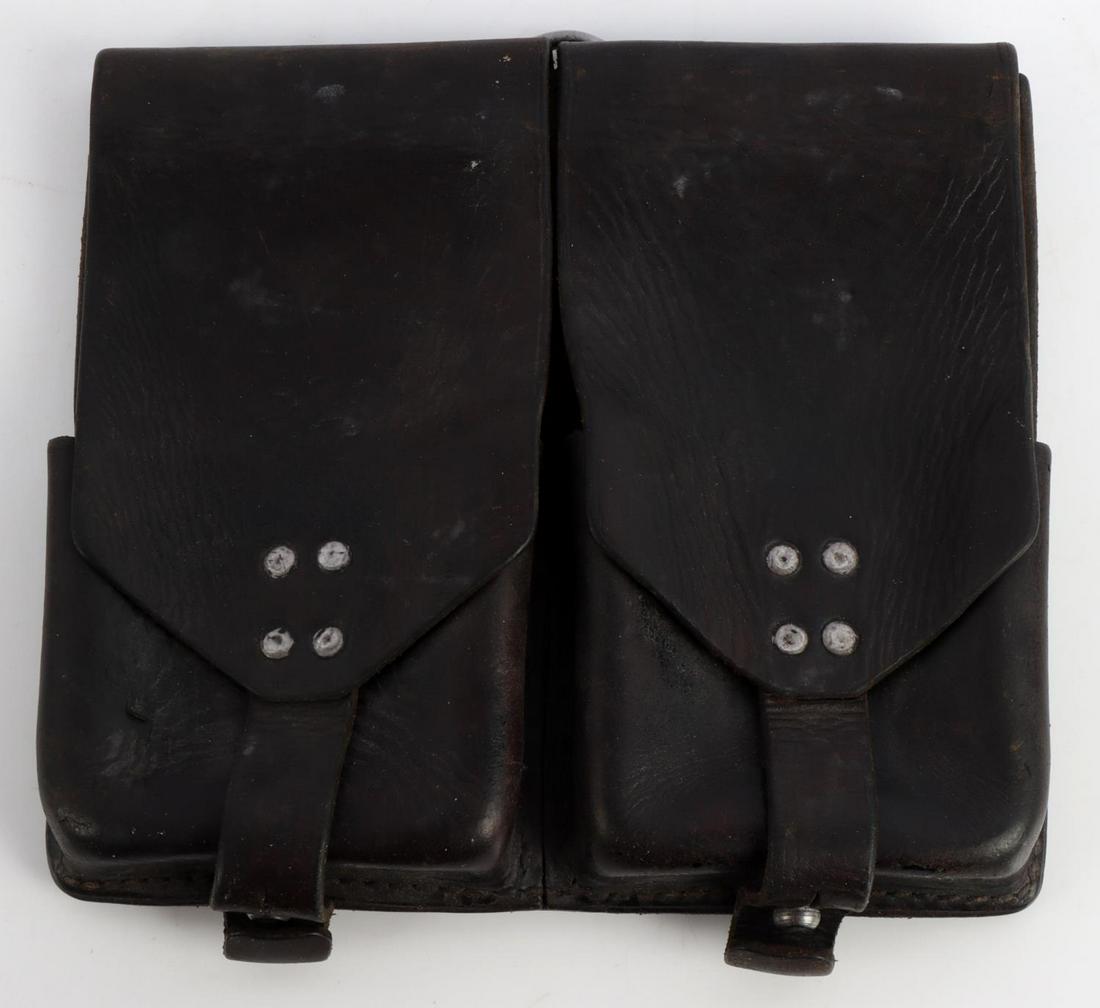 WWII GERMAN THIRD REICH WAFFEN SS LEATHER POUCH: German WWII Waffen SS Machine Gun Leather Clip Pouch. Measures 7 5/8 X 6 7/8 tall. The reverse side is maker marked ‘SIOLLA WIEN Ges Gesch. It is also stamped with apair of Waffen SS rune. There are