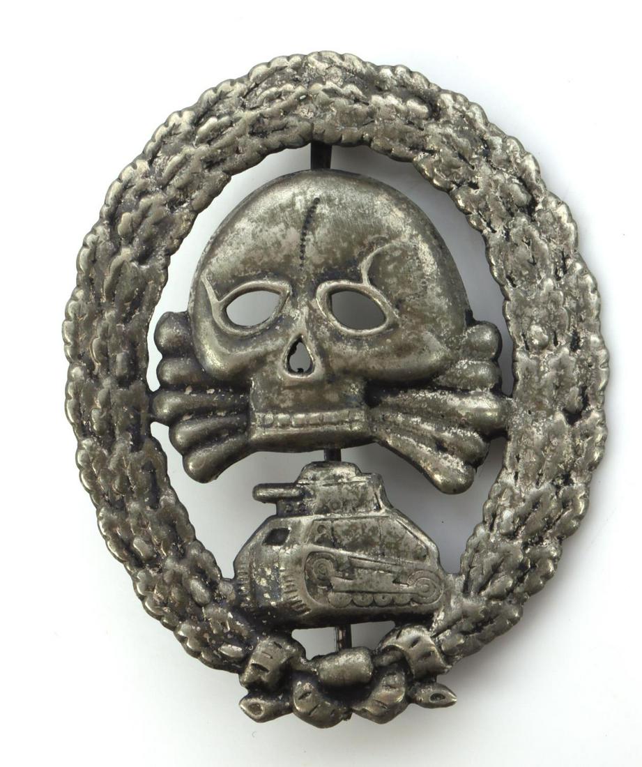 WWII GERMAN SPANISH CONDOR TANK ASSAULT BADGE: German WWII Spanish Condor Legion Tank Assault Badge. Measures 1 7/8 X 2 3/8 inches tall. The front shows a jawless skull and cross bones in the center with a tank below. Both are surrounded by an ova