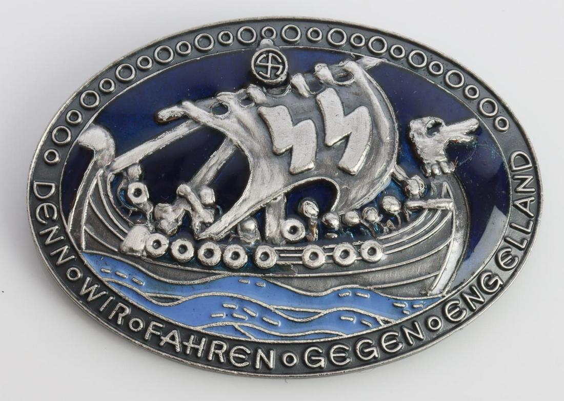 WWII GERMAN WAFFEN SS ENGLAND VICTORY BADGE: German World War II Waffen SS Victory In England Badge. Measures 1 3/4 X 1 1/4 inches. Front shows a Viking ship with a pair of Waffen SS runics in the sail. Reads ‘Denn – Fahren – Gegen – Eng