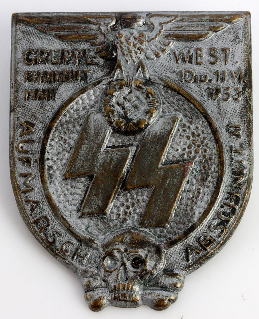 WWII GERMAN WAFFEN SS 1933 FRANKFURT BADGE: German WWII Waffen-SS 1933 Frankfurt Gruppe West Badge. Measures 1 3/8 X 1 3/4 inches. Front shows a Reichsadler at the top. Waffen-SS runes in the center and a totenkopf at the base. It reads ‘Grup