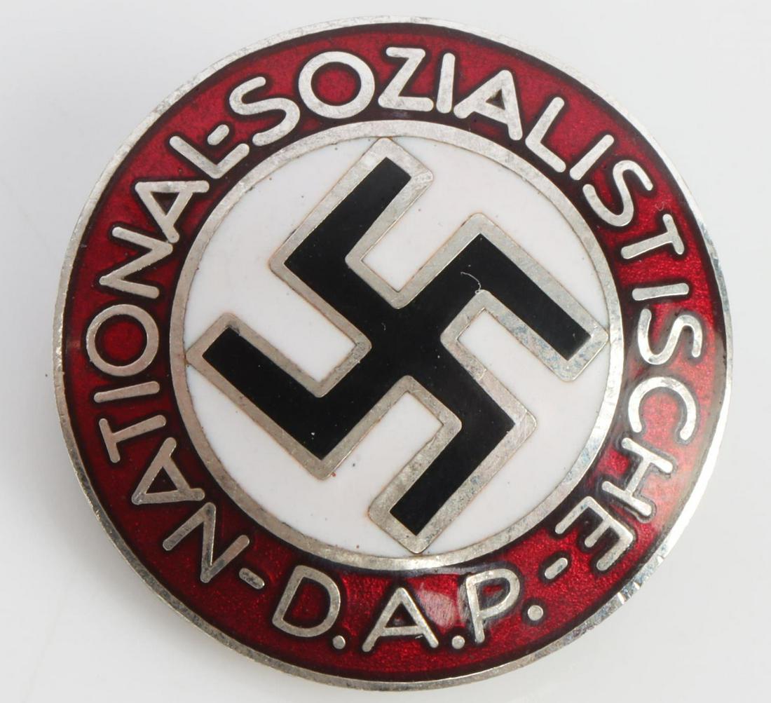 WWII GERMAN REICH NSDAP PARTY MEMBERSHIP BADGE: Measures 1 inches in diameter. The front reads ‘National Sozialistische DAP’. There is a swastika in the center. The reverse side is maker marked ‘M1/25 RZM’. Has a thin horizontal safety pin
